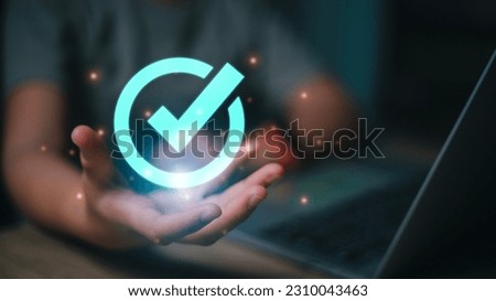 Concept of Internet business technology digital. Women choose options Checkmark, which means Standard quality control certification assurance guarantee.  Royalty-Free Stock Photo #2310043463