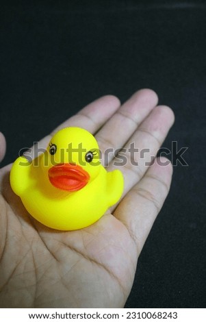 A photo of Cute little yellow toy duck with red lips