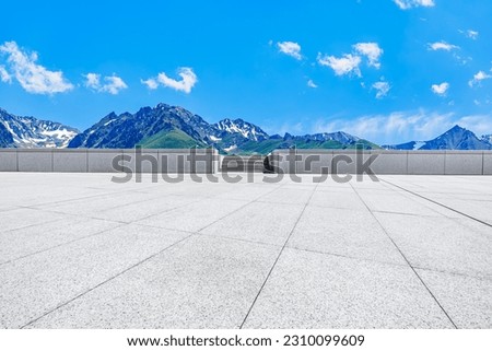 Empty square floor and mountain background.