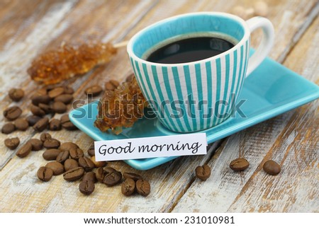 Good morning card with vintage cup of coffee on rustic wooden surface 