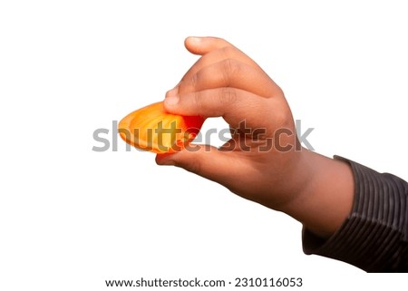 A man holds a part of an orange and the background is isolated on white