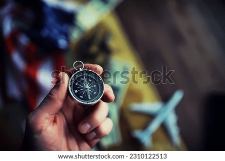 Magnetic compass. The concept of finding successful solutions to problems. Compass, map, sleeves, hands.