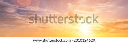 The rays of the sun breaking through the dramatic clouds in the evening or in the morning in the sunset or dawn sky. The concept of faith, hope for the best or good weather. Royalty-Free Stock Photo #2310124629