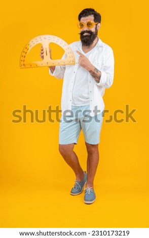 man hold geometry protractor on background, point finger. photo of man hold geometry protractor.