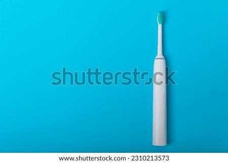 Sonic electric toothbrush on a blue background. Oral hygiene. Dental care. Dentistry concept. Place for text. Place to copy.