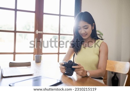 Happy young Asian Woman photographer holding camera Creative female freelancer working Blog. Blogging Homepage Social Media.