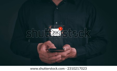 Business e-mail communication and digital marketing. Businessman holding mobile and touching with virtual white newsletter for electronic mail or E-mail with notification alert concept.