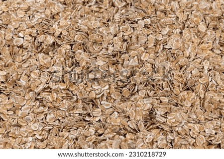 a bunch of fresh dry oatmeal flakes for making porridge, a large number of large oatmeal flakes for making breakfast Royalty-Free Stock Photo #2310218729