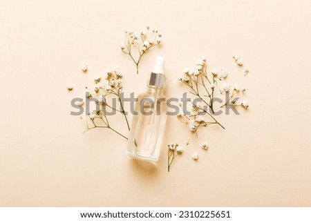 Fancy healthcare bottles for serum, micellar, tonic, toner, lotion, water and cream with gypsophila branch. Natural oranic spa cosmetics concept. Mockup, template, Top view.