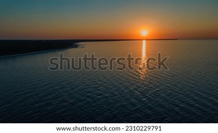 Beautiful sunset in Latvia beach near sea, Orange sky and orange sunset captured by drone. 