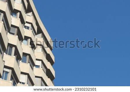 Minimal corner of modernist building against clear sky. Horizontal photo with backdrop. Faded photo