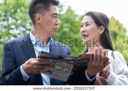 Japanese couple looking at a pamphlet