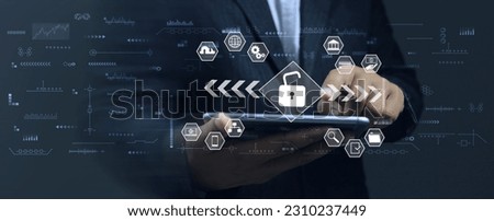 Businessman unlocks smartphone to access financial applications find market information or transfer money for trading Cyber security and ISO 27001 information technology concept. Royalty-Free Stock Photo #2310237449