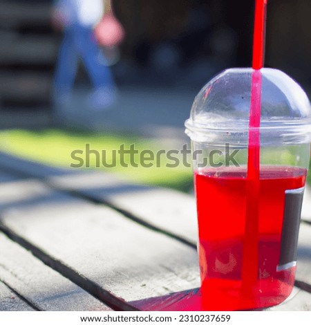 Picture of red juice in summer on the beach
