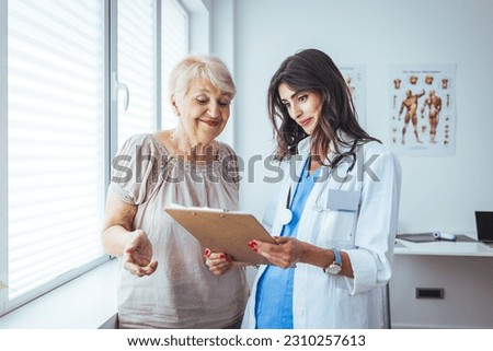 Smiling caring young female nurse doctor caretaker assisting happy senior grandma helping old patient in rehabilitation recovery at medical checkup visit, elder people healthcare homecare concept