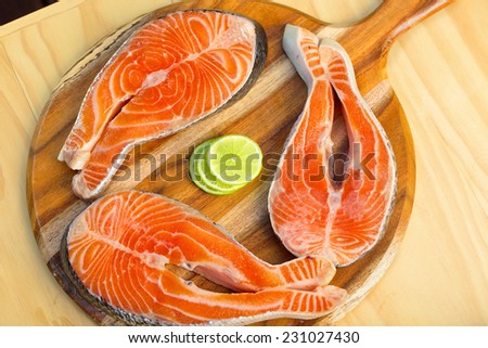 Delicious  portion of fresh salmon fillet  with lemon and vegetables