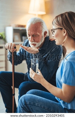 Medicine And Health Care Concept. Smiling young doctor showing elderly male patient pills, pointing at tablets. Female specialist prescribing mature man treatment, painkiller or vitamin
