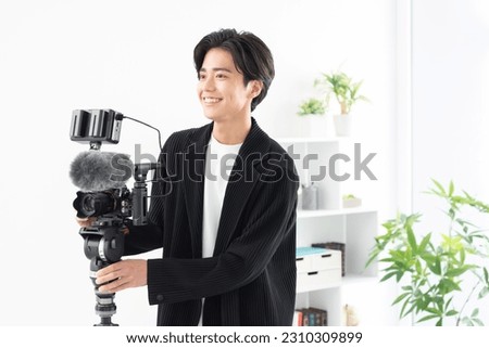 Asian cameraman shooting a video