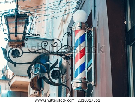 Signboard pole spinning on barbershop.