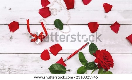Bouquet of flowers roses of the valley and letter on wooden table from above, top view, flat lay