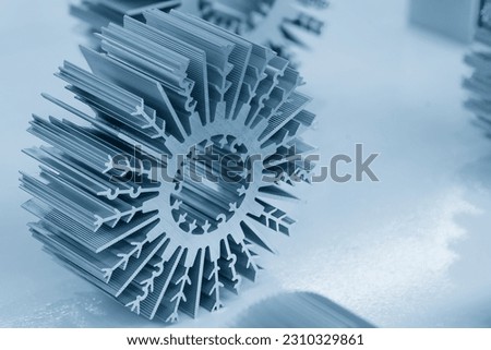 The sample parts of aluminum profile extrusion manufacturing concept. The circular shape of aluminum heat sink profile.  Royalty-Free Stock Photo #2310329861