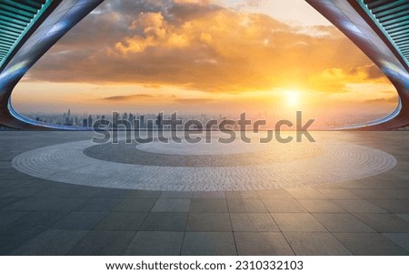 Empty square floors and bridge with the city skyline at sunset in Shanghai