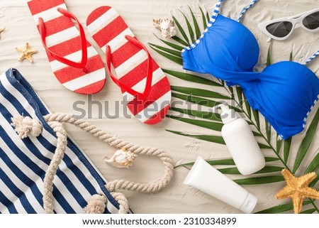 Elevate your summer style! Top view of sunglasses, beach bag, flip-flops, swimsuit, sunscreen bottles, seashell, starfish, palm leaves on a sandy background Royalty-Free Stock Photo #2310334899