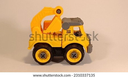 Heavy equipment toy for kids. Yellow backhoe truck