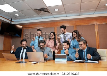 Indian businesspeople group celebrate after dealing feel happy and signing contract or agreement at meeting room