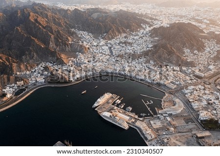 A picture of muscat from the sky showing the beauty of the sea, the markets, and the proximity of the royal yachts

