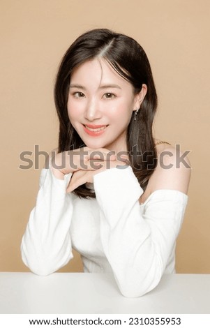 Young Asian beauty woman short hair with korean makeup style on face and perfect clear fresh skin on isolated beige background. Facial treatment, Cosmetology, plastic surgery.
