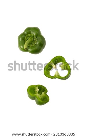 Falling Green bell pepper slice isolated on white background with clipping path. Royalty-Free Stock Photo #2310363335