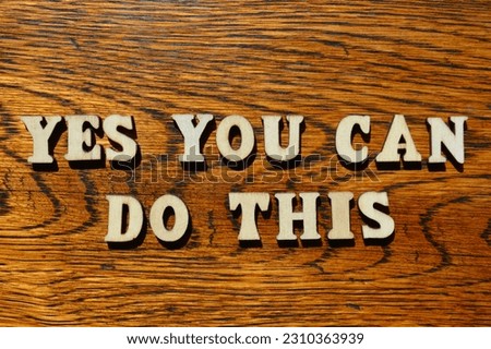 Yes You Can Do This, words in wooden alphabet letters isolated on antique oak wood background