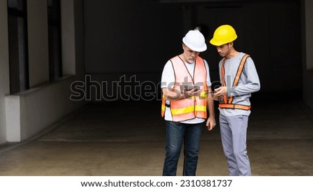 Senior  Architect contractor and team engineering inspecting building structure in construction site.  height restriction bar with hanger assemblies and chains over the entrance 