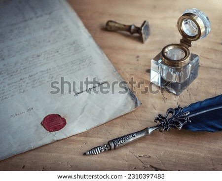 Old Fountain pen, quill pen, and old paper blank sheet and vintage inkwell on wooden desk in the old office . Retro style. Conceptual background on history, education, literature topics. Royalty-Free Stock Photo #2310397483