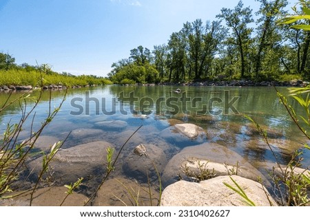 Bow River views in Calgary, Alberta during summer time with secluded pond seen in the city during spring time. 