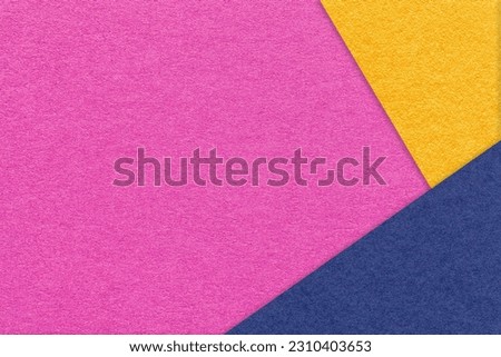 Texture of craft magenta color paper background with navy blue and yellow border. Vintage abstract purple cardboard. Presentation template and mockup with copy space. Felt lilac backdrop closeup.