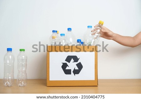 Volunteer keep plastic bottle into paper box at home or office. Hand Sorting Recycle garbage. Ecology, Environmental, pollution, Dispose recycling, waste management and trash Separation concept