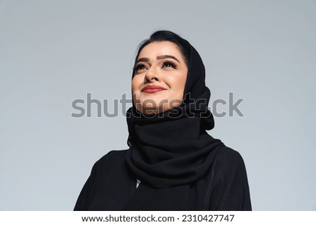 Beautiful arab middle-eastern woman with traditional abaya dress in studio - Arabic muslim adult female portrait in Dubai, United Arab Emirates Royalty-Free Stock Photo #2310427747