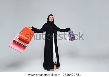 Beautiful arab middle-eastern woman with traditional abaya dress in studio - Arabic muslim adult female portrait in Dubai, United Arab Emirates Royalty-Free Stock Photo #2310427751