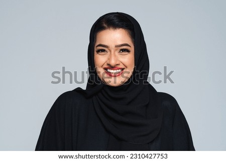 Beautiful arab middle-eastern woman with traditional abaya dress in studio - Arabic muslim adult female portrait in Dubai, United Arab Emirates Royalty-Free Stock Photo #2310427753