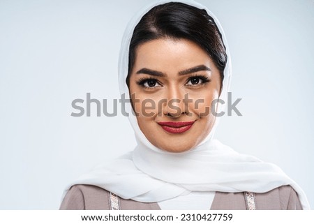 Beautiful arab middle-eastern woman with traditional abaya dress in studio - Arabic muslim adult female portrait in Dubai, United Arab Emirates Royalty-Free Stock Photo #2310427759