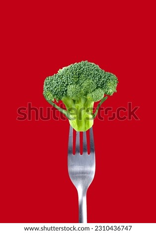 Tasty ripe green broccoli on fork