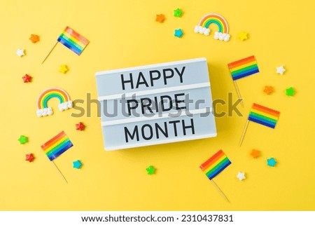 LGBTQ pride month background with rainbow flag and light box text. Top view, flat lay