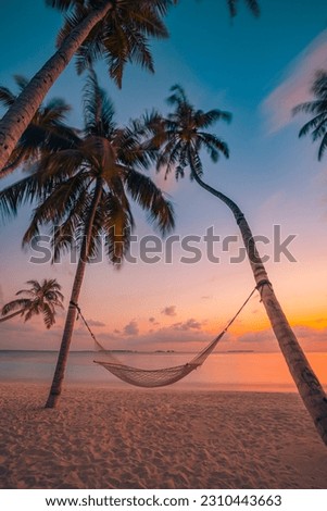 Beautiful silhouette of hammock on palm trees on tropical beach paradise at sunset. Carefree freedom concept, summer nature, exotic shore coast. Tranquil travel landscape. Enjoy life, positive energy Royalty-Free Stock Photo #2310443663