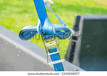 Detail of ratchet strap connected to concrete block Royalty-Free Stock Photo #2310458597