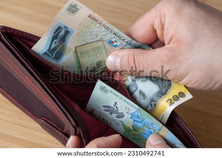 wallet with money, banknotes of 1 and 200 romanian lei, financial and economic concept, household situation, inflation and price increase in romania Royalty-Free Stock Photo #2310492741