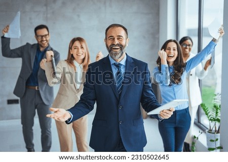 Euphoric excited business team celebrate corporate victory together in office, happy overjoyed professionals group rejoice company victory, teamwork success win triumph concept at conference table