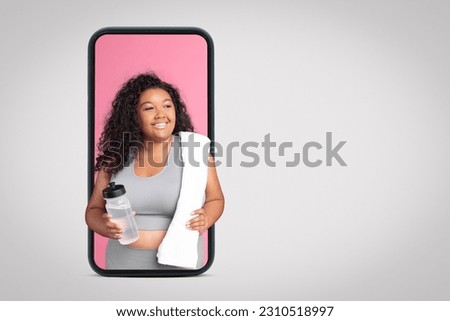 Positive black oversize woman in sportswear with bottle of water on smartphone screen on grey studio background, collage, free space. Fit blog, workout, weight loss and health care