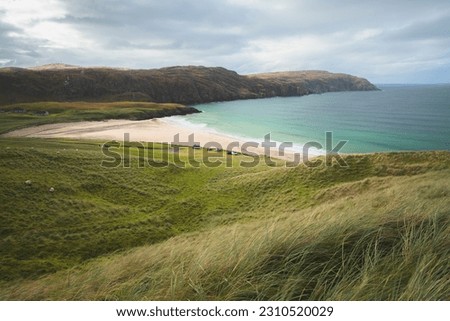 Beautiful seascape landscape over headland and sandy bay at Reef Beach on the Isle of Lewis and Harris in the Outer Hebrides of Scotland, UK. Royalty-Free Stock Photo #2310520029
